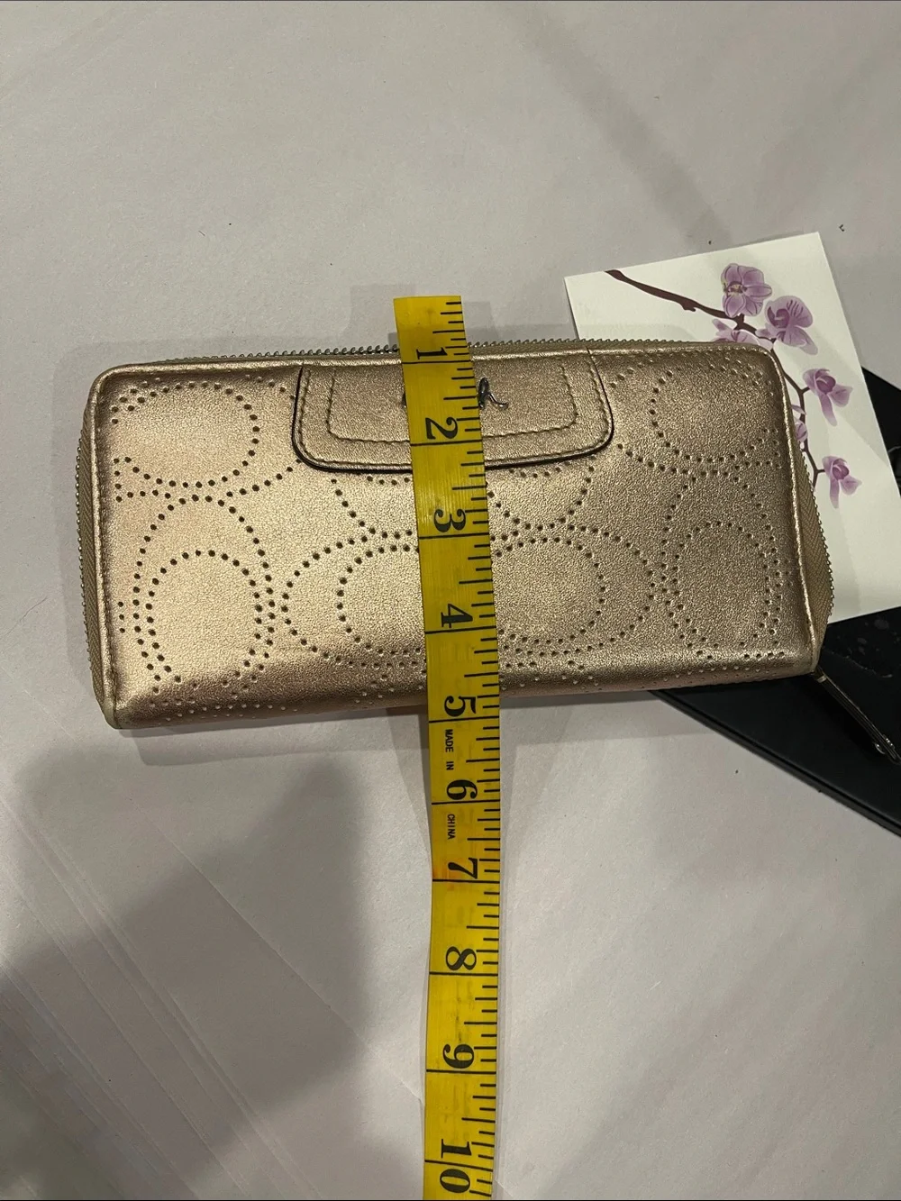 Coach Ashley perforated zip-around wallet.